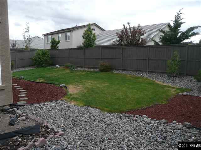 460 Sysonby Court Reno, NV 89521 - Photo 7 of 8 a view of a backyard with green space
