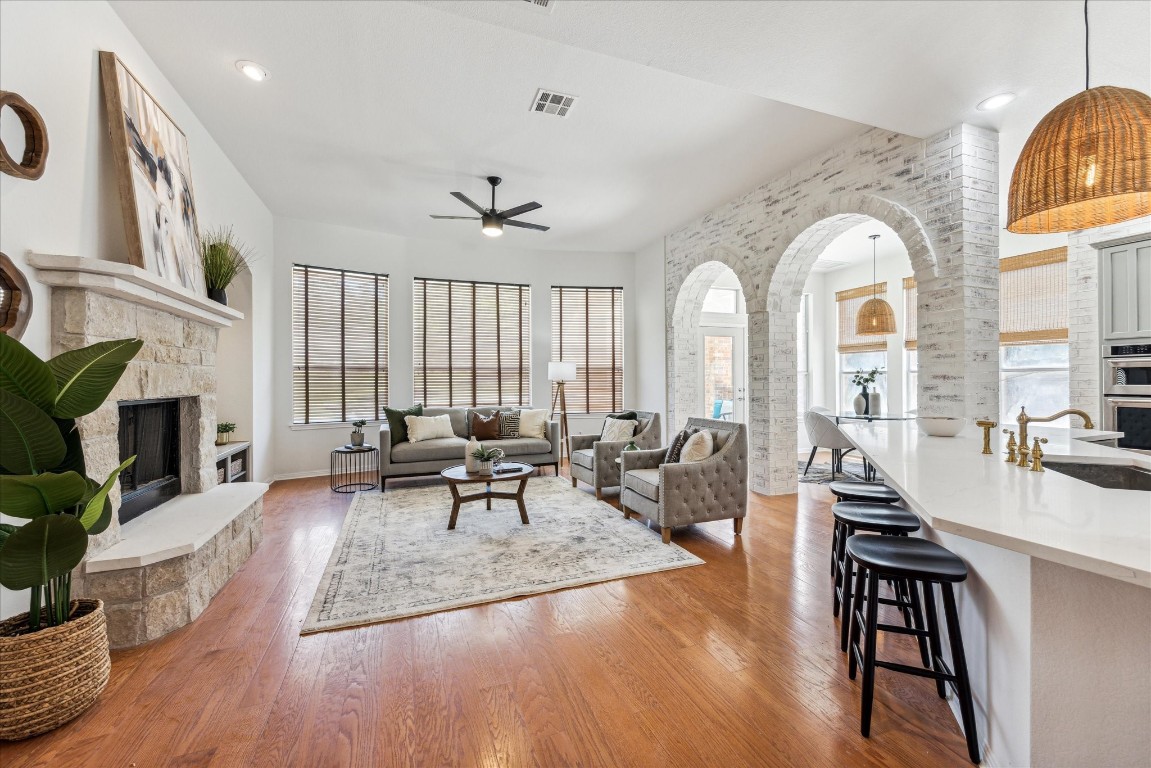 a living room with furniture a fireplace and a large window