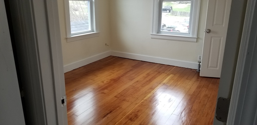 1260 Grafton Street Worcester, MA 01604 - Photo 18 of 42 an empty room with wooden floor and windows