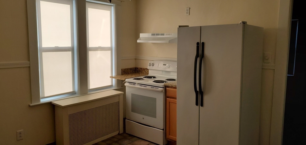 1260 Grafton Street Worcester, MA 01604 - Photo 24 of 42 a kitchen with a refrigerator and window