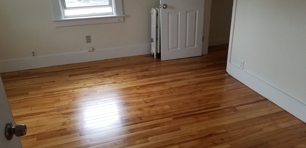 1260 Grafton Street Worcester, MA 01604 - Photo 30 of 42 a view of an empty room with wooden floor and a window