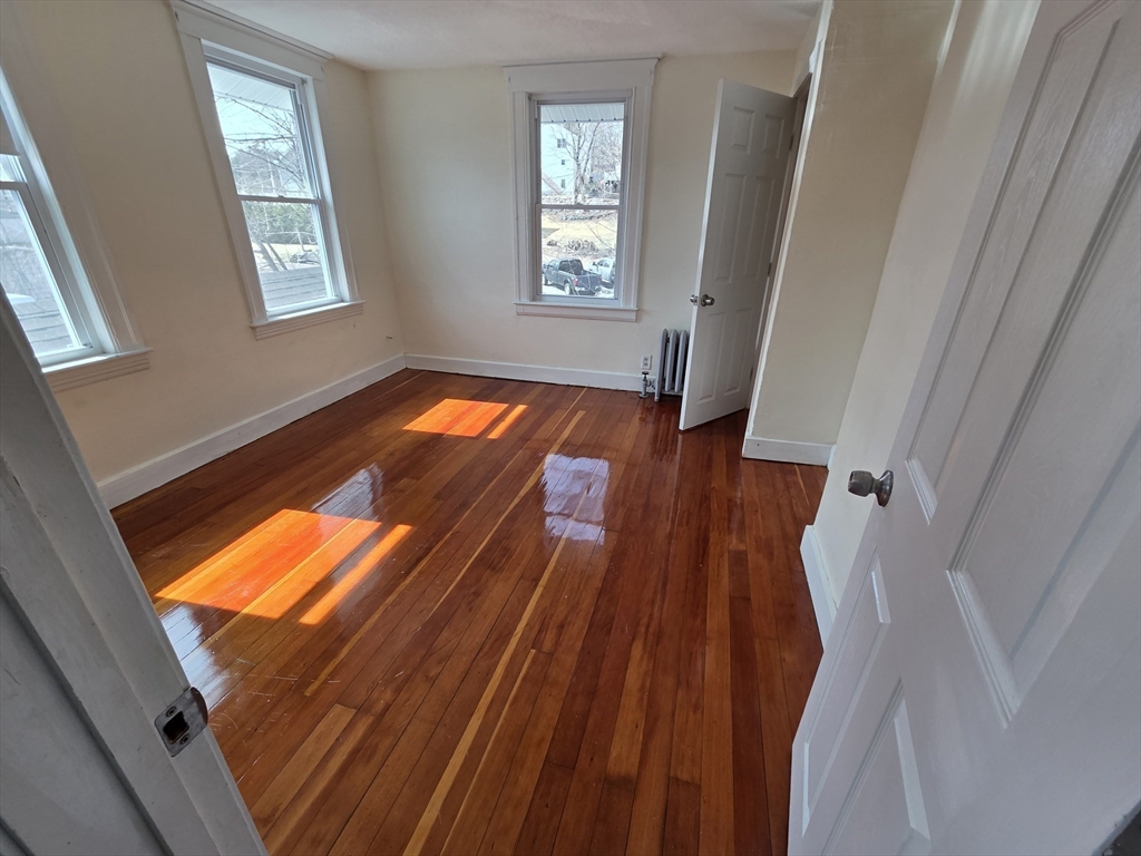 1260 Grafton Street Worcester, MA 01604 - Photo 34 of 42 a view of an empty room with wooden floor and a window