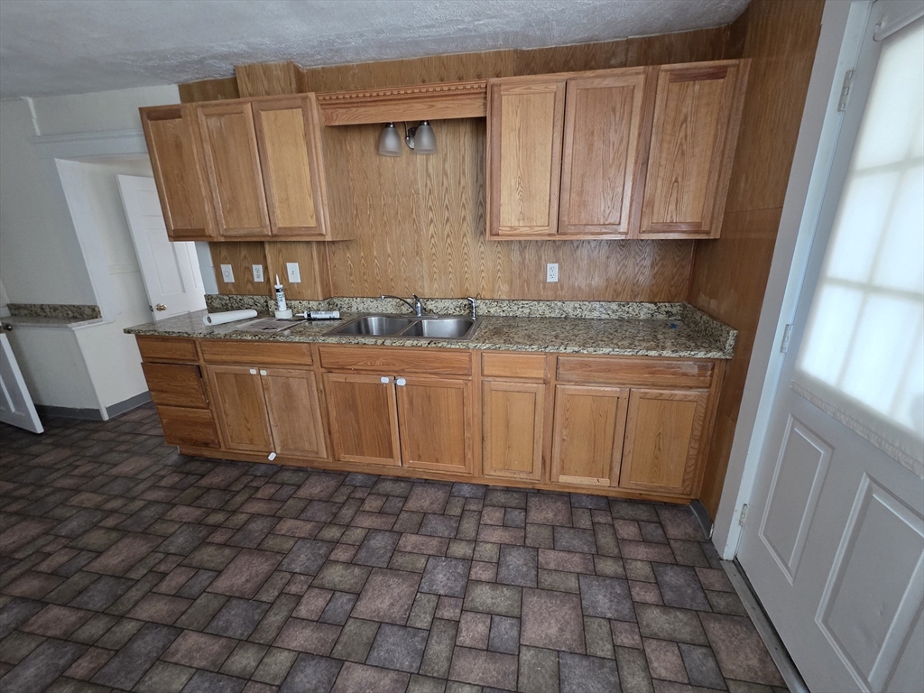 1260 Grafton Street Worcester, MA 01604 - Photo 40 of 42 a kitchen with a sink a stove and cabinets