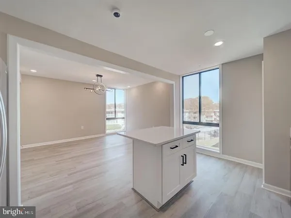 a large white room with wooden floor