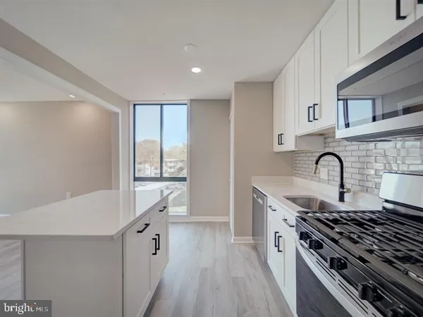 a kitchen with granite countertop a stove and a sink