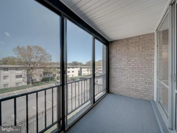a view of a balcony with furniture and city view