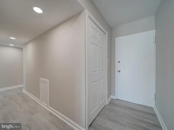an empty room with wooden floor and closet