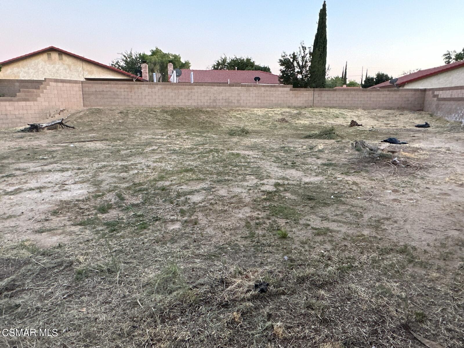 1200 Pasteur Drive Lancaster, CA 93535 - Photo 25 of 32 a view of a dry yard with wooden fence