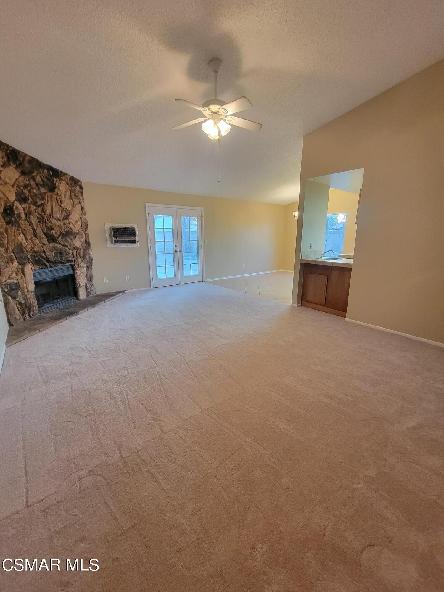 1200 Pasteur Drive Lancaster, CA 93535 - Photo 4 of 32 an empty room with windows and fireplace