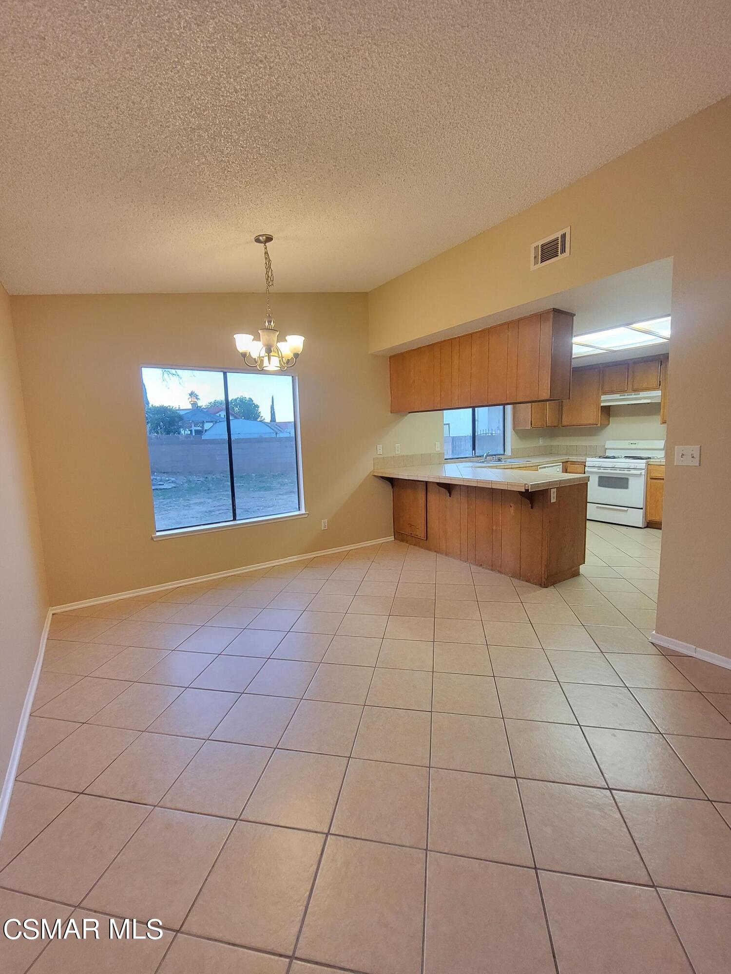 1200 Pasteur Drive Lancaster, CA 93535 - Photo 6 of 32 a view of a room with window and chandelier
