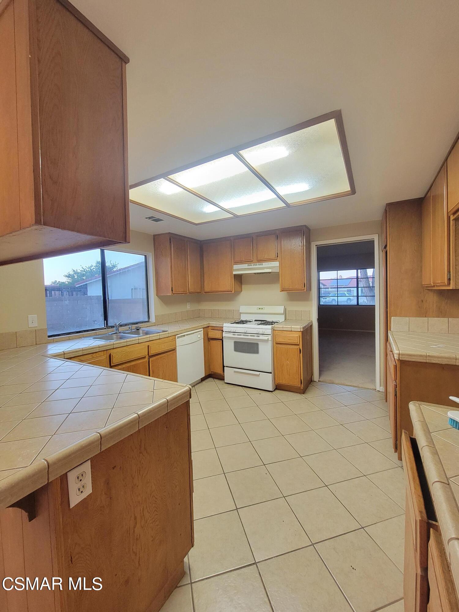 1200 Pasteur Drive Lancaster, CA 93535 - Photo 7 of 32 a kitchen with stainless steel appliances cabinets a sink and a stove