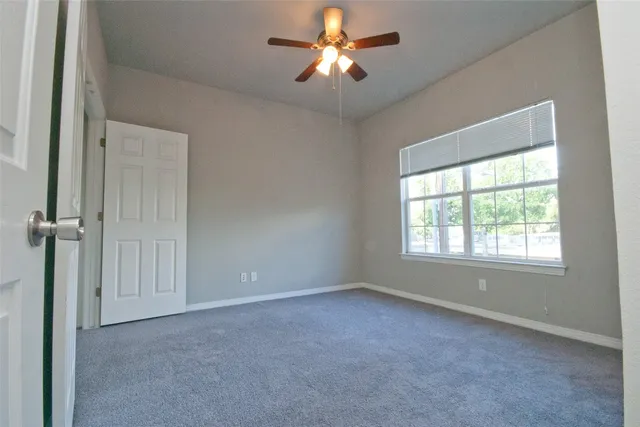 a view of empty room with fan