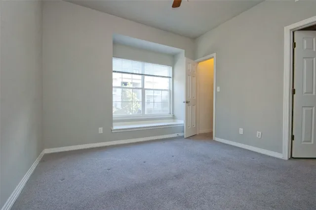 an empty room with windows and closet