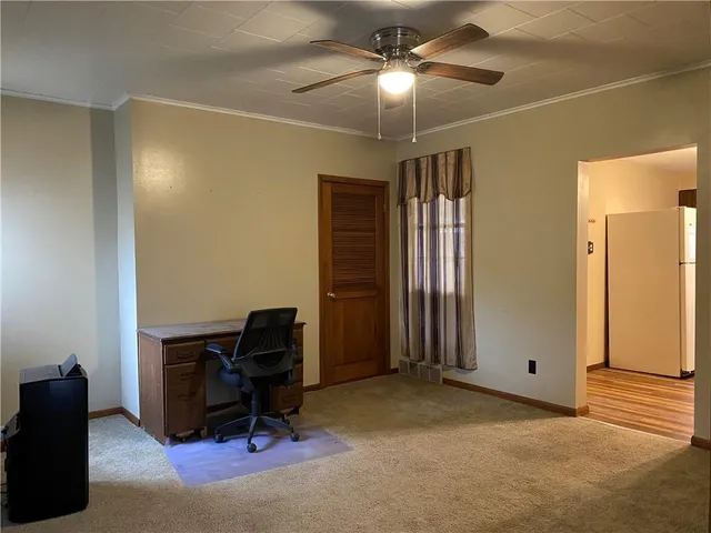 a view of workspace with hardwood floor and ceiling fan