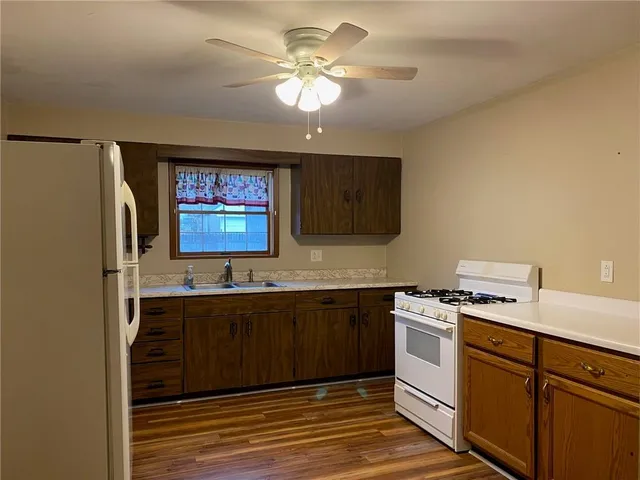 a kitchen with a sink stove and cabinets