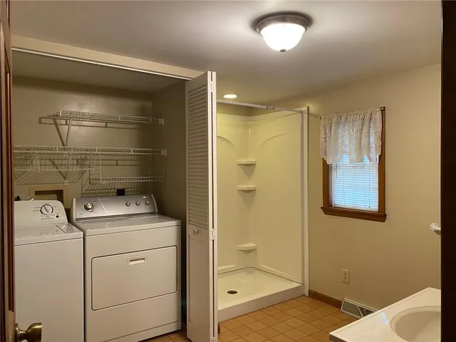 a bathroom with a shower and mirror