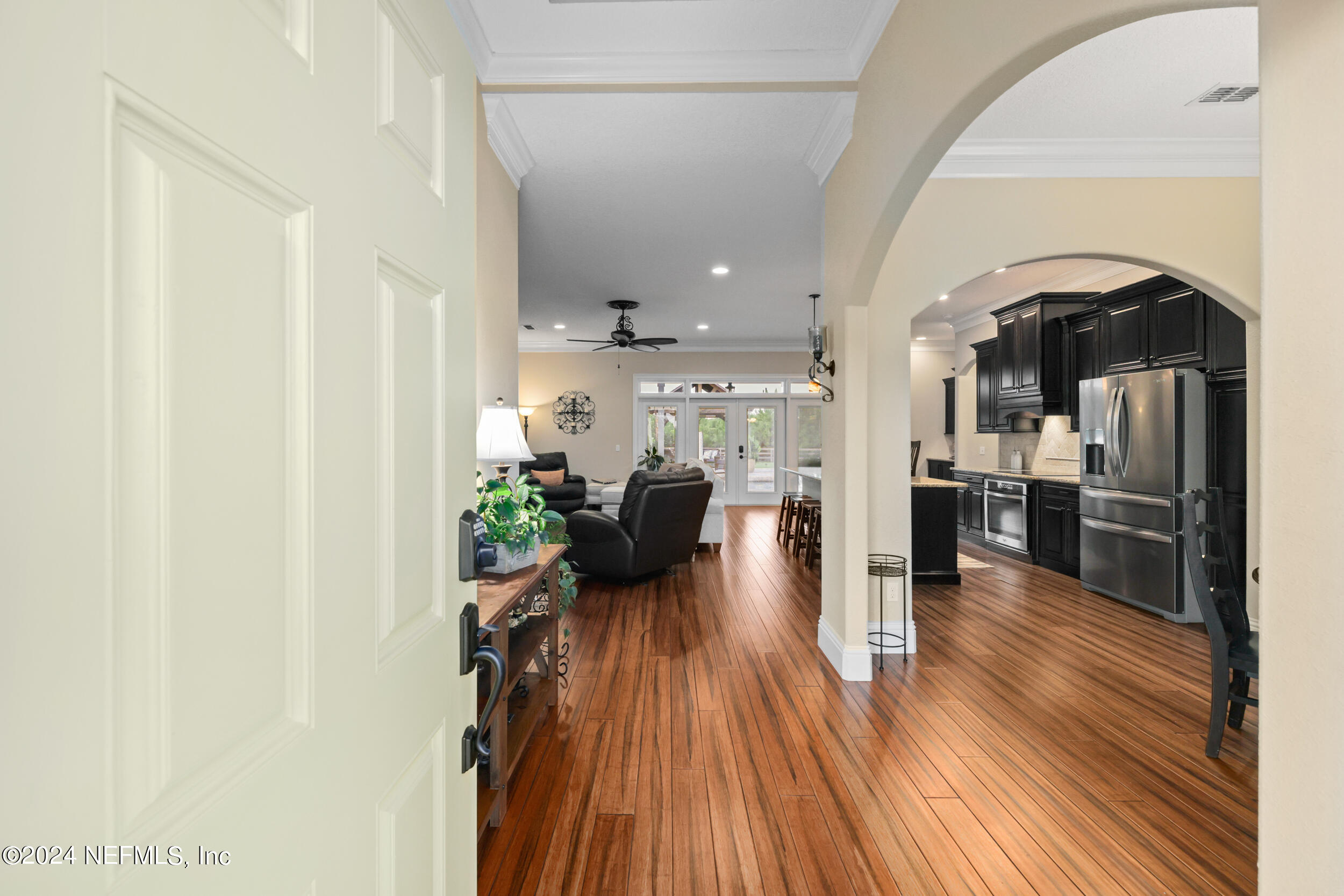 55278 Bartram Trail Callahan, FL 32011 - Photo 11 of 88 a view of a living room kitchen with furniture and wooden floor