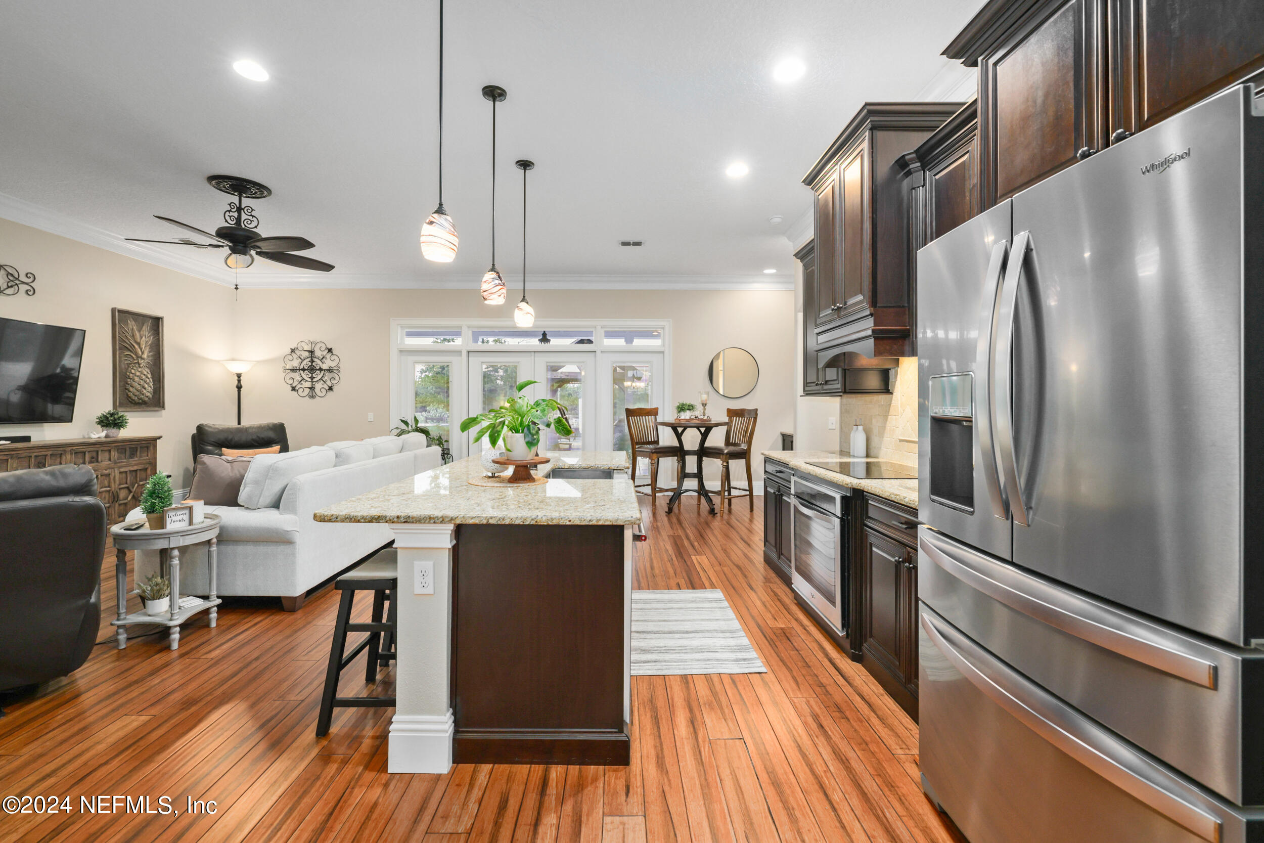 55278 Bartram Trail Callahan, FL 32011 - Photo 13 of 88 a kitchen with stainless steel appliances a dining table chairs stove refrigerator and cabinets