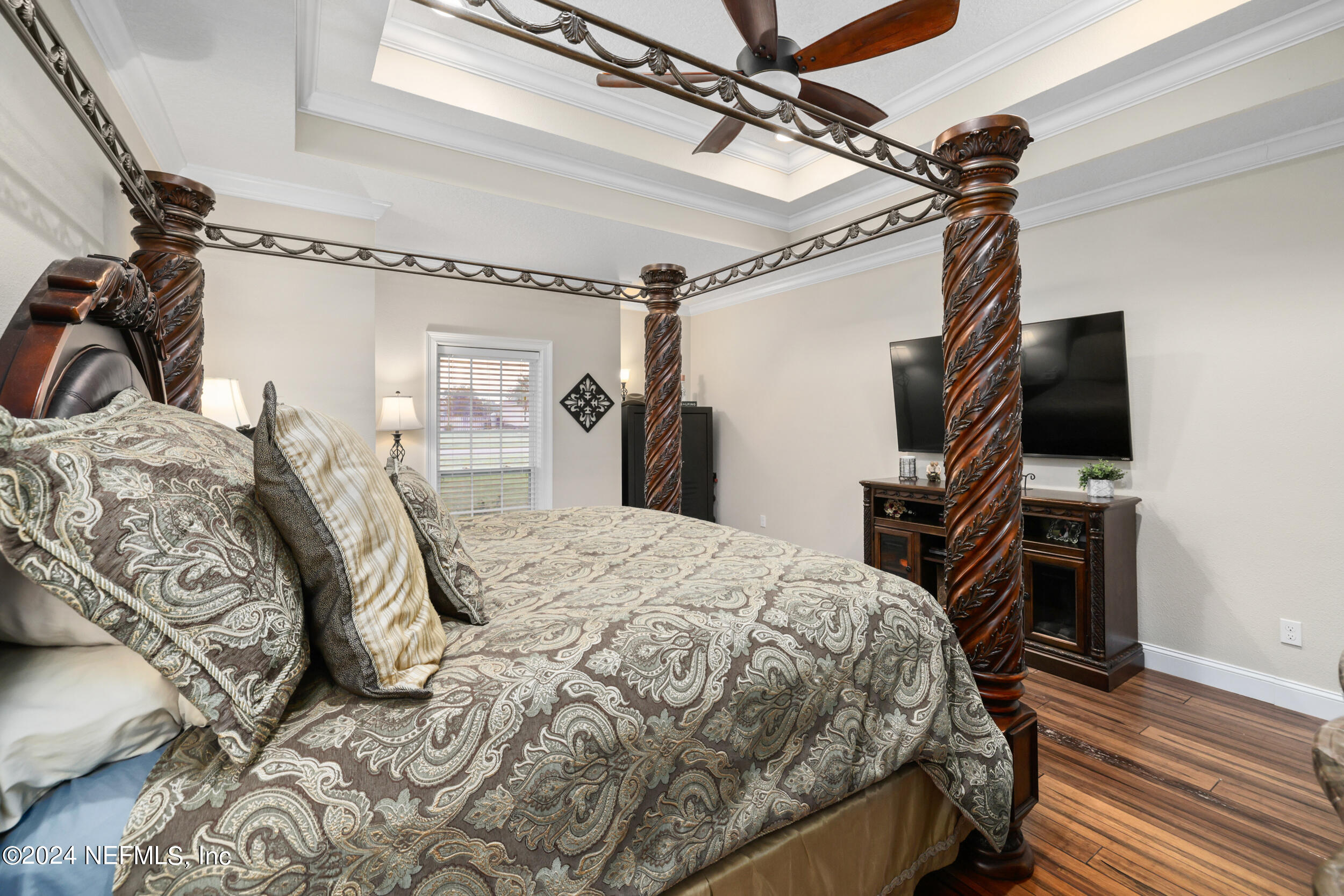 55278 Bartram Trail Callahan, FL 32011 - Photo 20 of 88 a bedroom with a bed and a flat screen tv