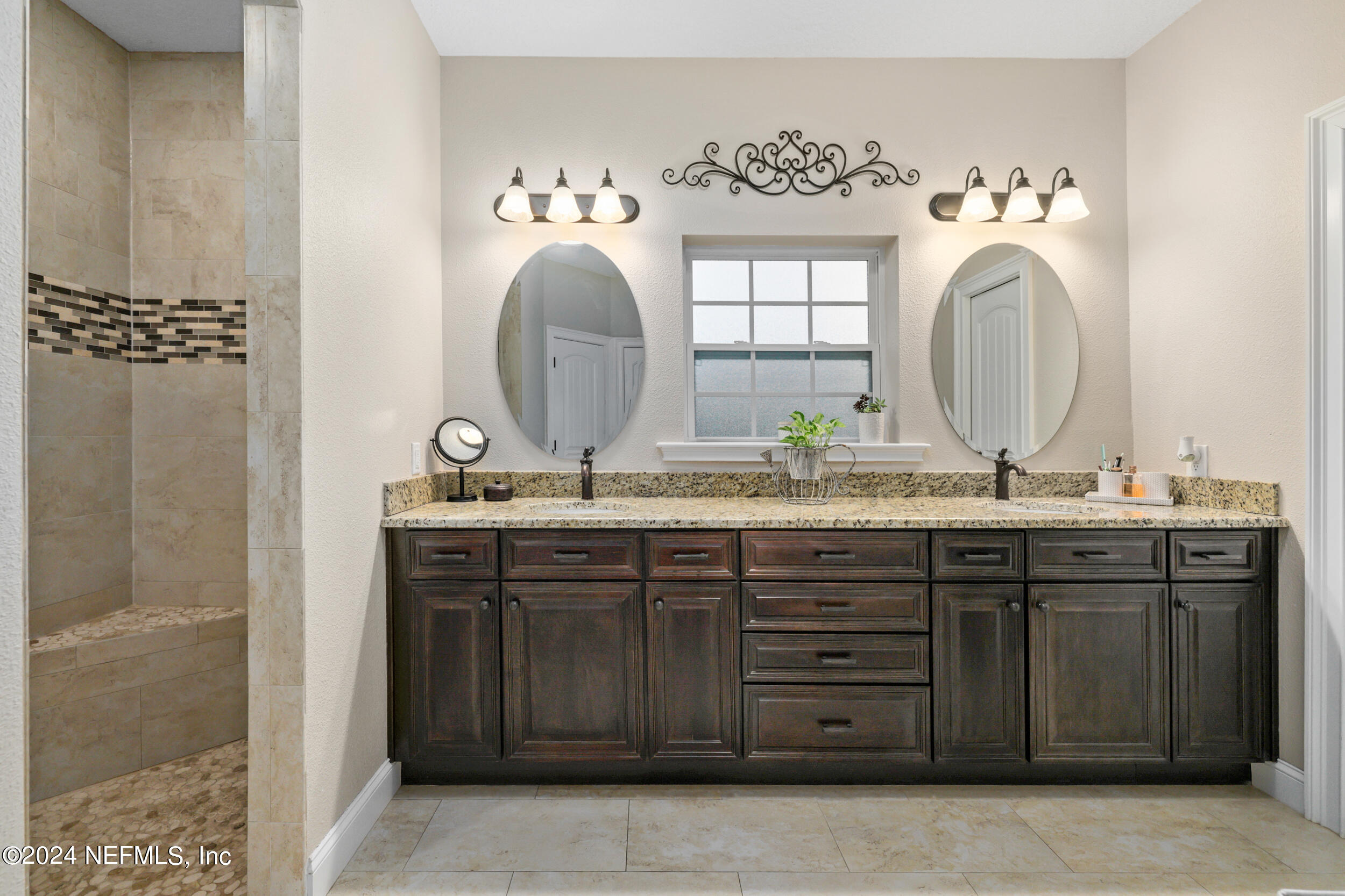 55278 Bartram Trail Callahan, FL 32011 - Photo 21 of 88 a bathroom with a granite countertop sink and a mirror