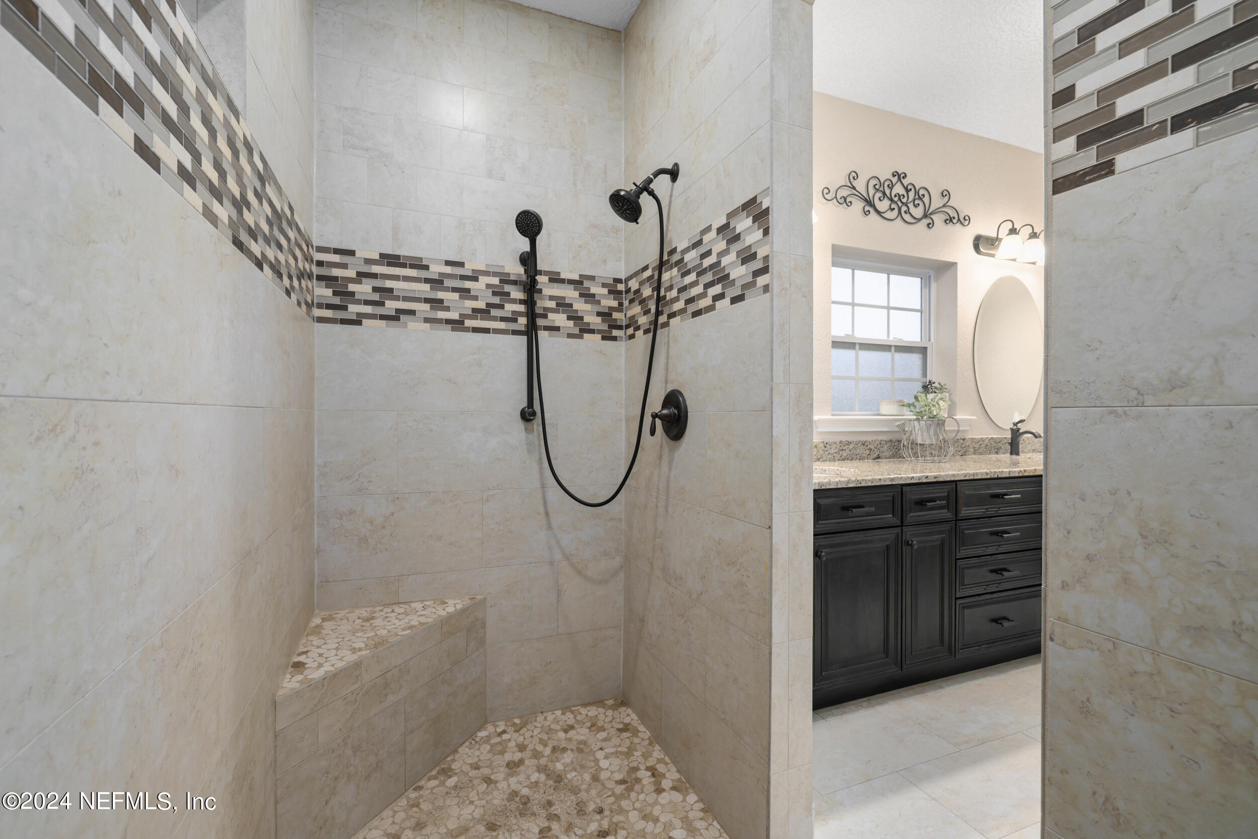 55278 Bartram Trail Callahan, FL 32011 - Photo 22 of 88 a bathroom with a granite countertop sink a mirror and shower