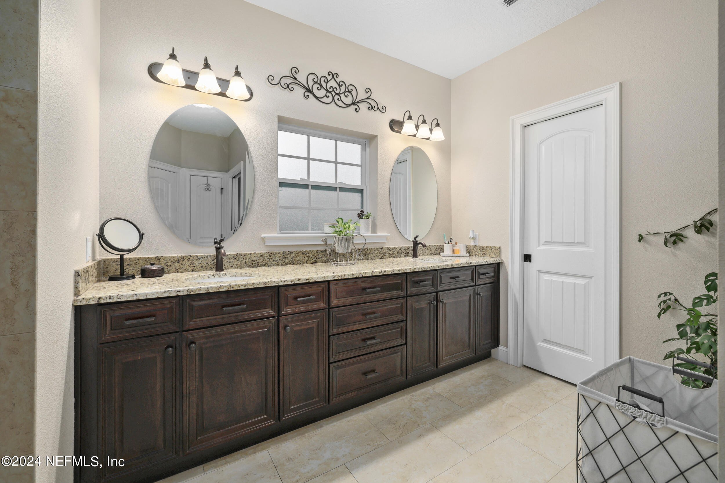 55278 Bartram Trail Callahan, FL 32011 - Photo 24 of 88 a en suite bathroom with a double vanity sink and a mirror