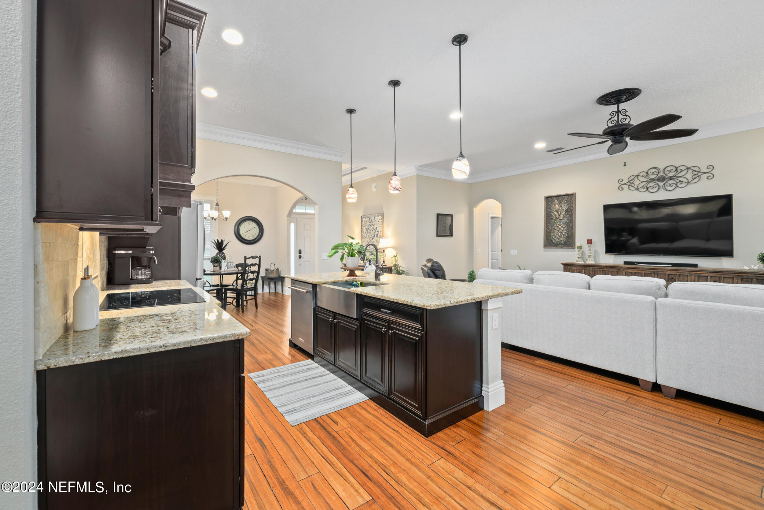 55278 Bartram Trail Callahan, FL 32011 - Photo 29 of 88 a kitchen with stainless steel appliances granite countertop a sink a stove and a wooden floors