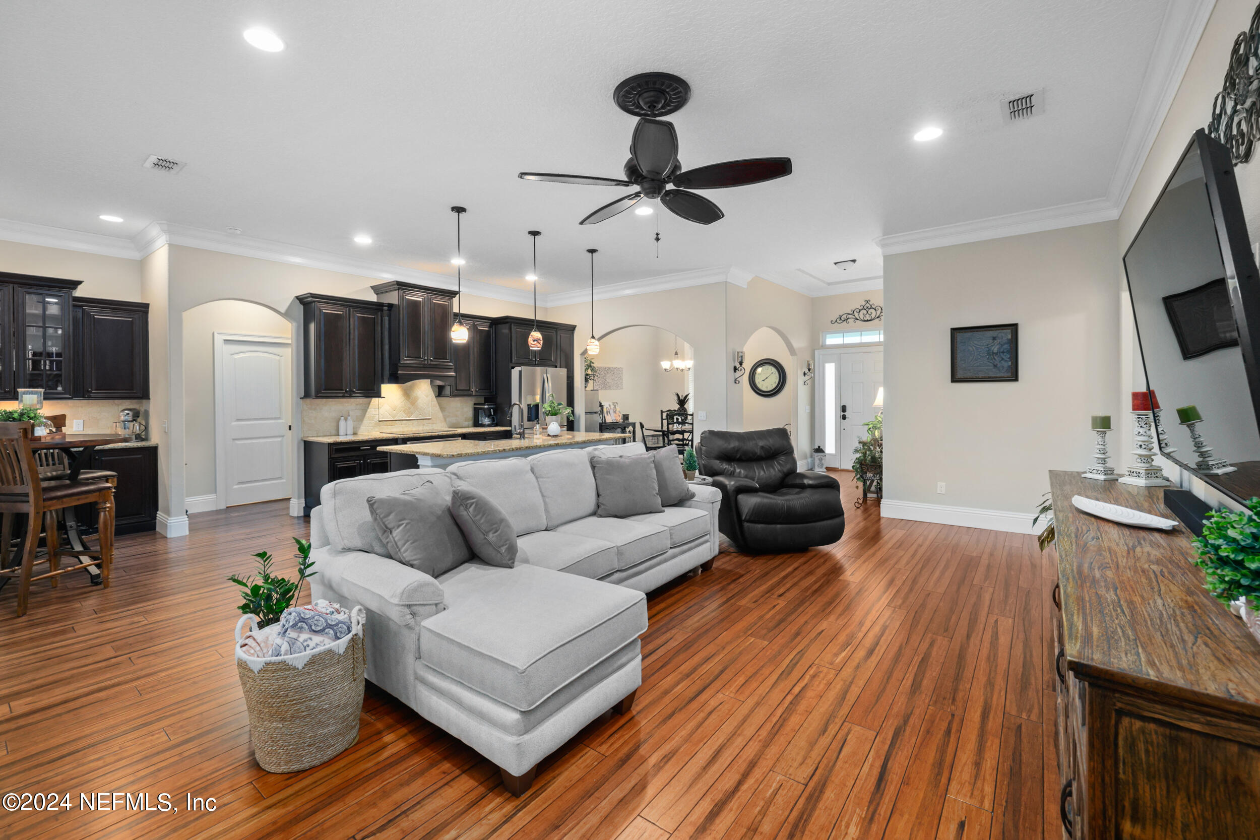 55278 Bartram Trail Callahan, FL 32011 - Photo 31 of 88 a living room with furniture kitchen view and a wooden floor