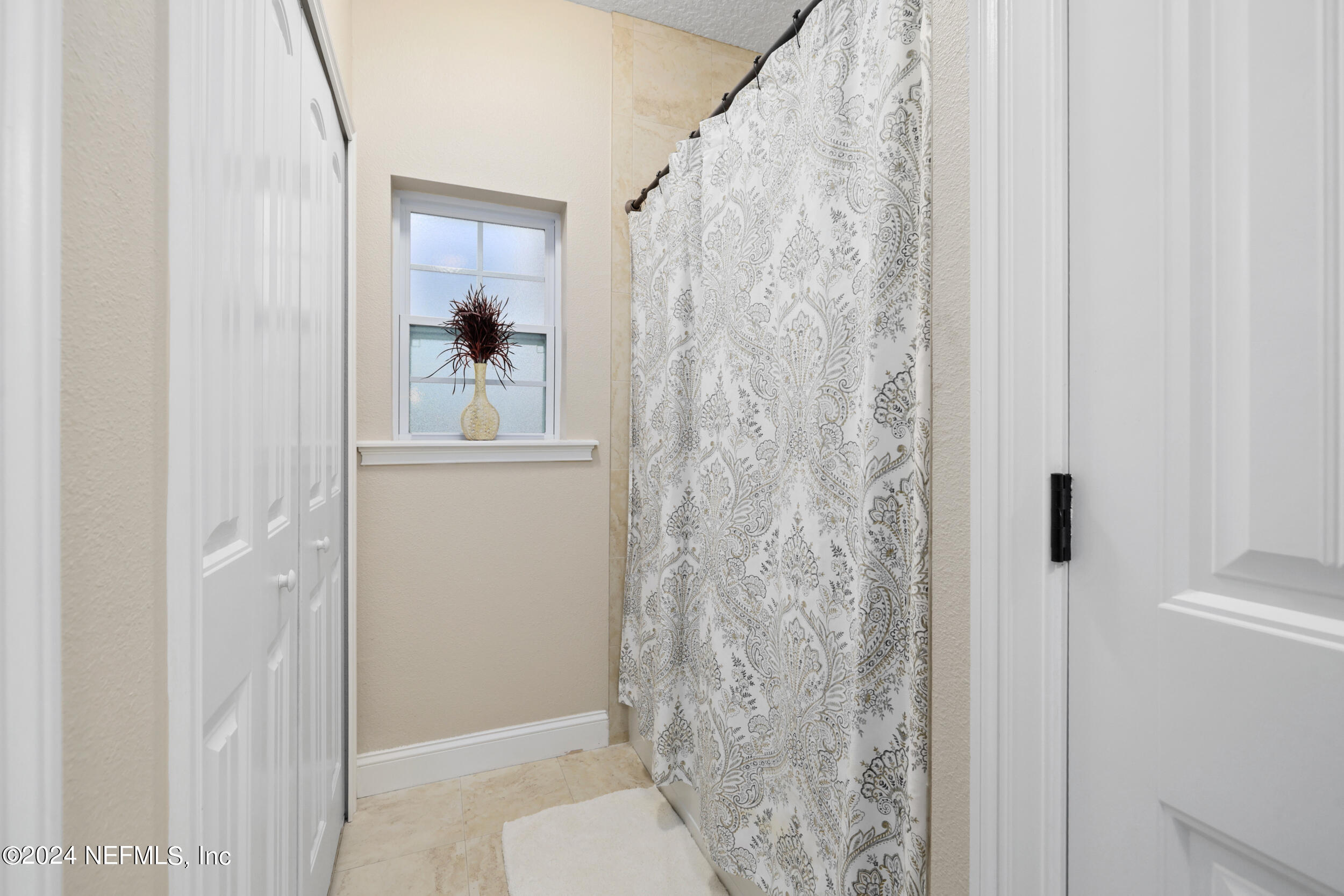 55278 Bartram Trail Callahan, FL 32011 - Photo 35 of 88 a bathroom with a shower curtain and a sink