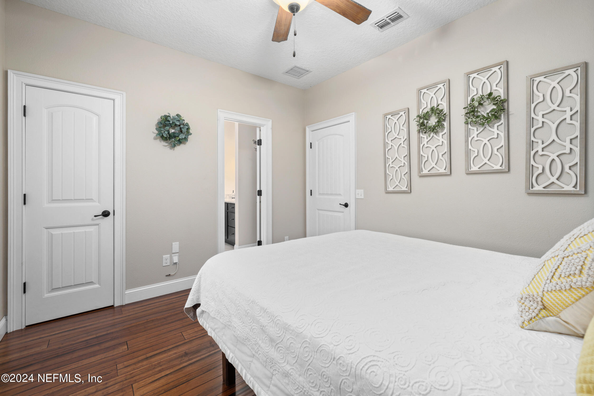 55278 Bartram Trail Callahan, FL 32011 - Photo 37 of 88 a bedroom with a bed and a chandelier