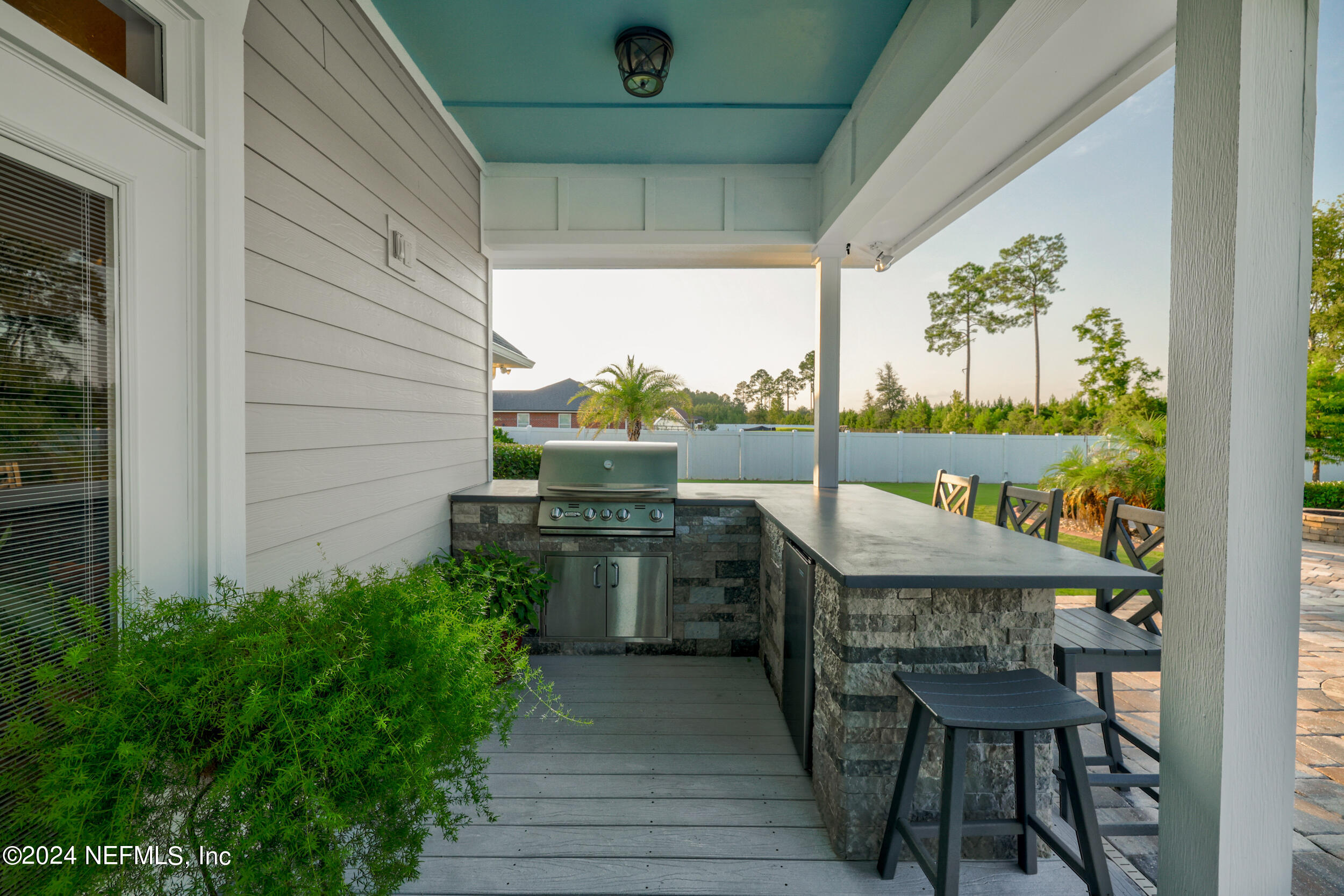 55278 Bartram Trail Callahan, FL 32011 - Photo 46 of 88 a view of a deck with table and chairs potted plants with wooden floor