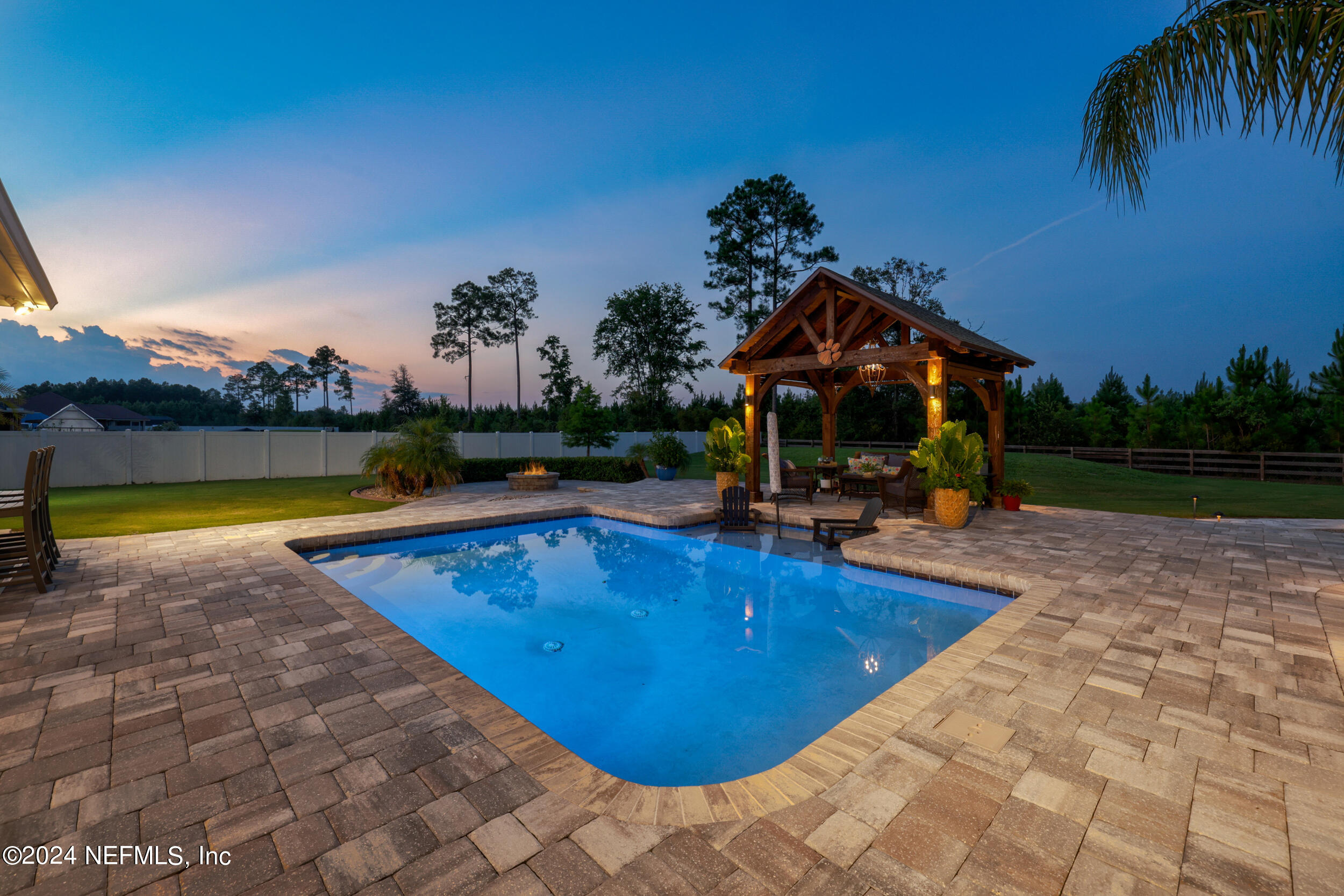 55278 Bartram Trail Callahan, FL 32011 - Photo 58 of 88 a view of swimming pool with outdoor seating and garden