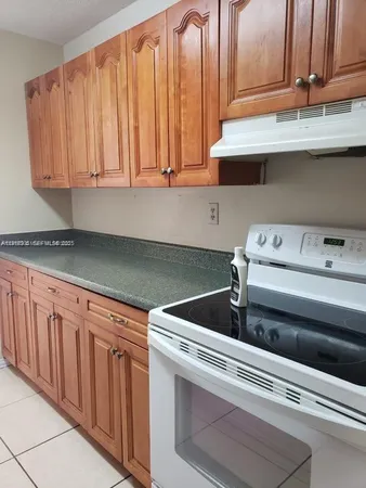 a close view of a sink and cabinets