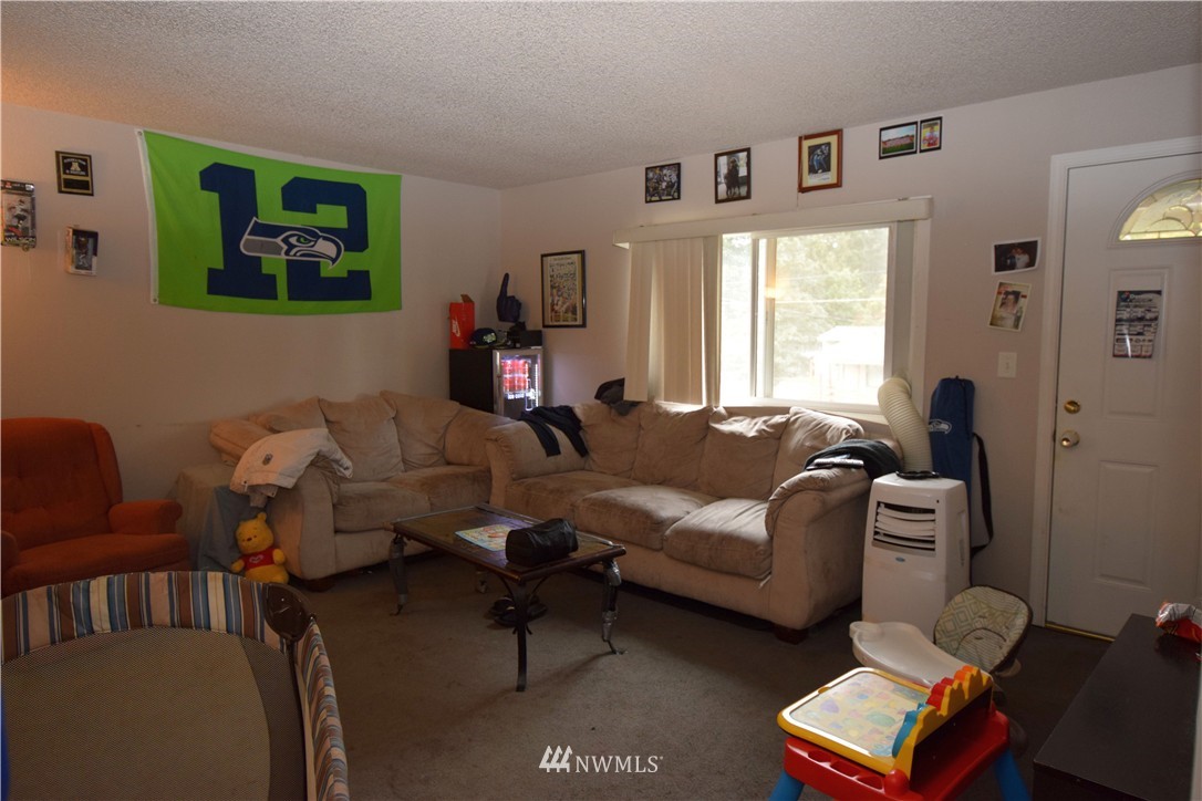 620 Index Avenue Northeast Renton, WA 98056 - Photo 3 of 17 a living room with furniture a rug and a window