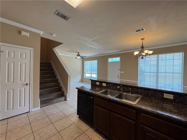 a bathroom with a granite countertop toilet a sink and a mirror