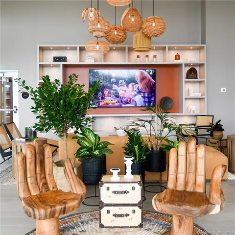 a dining room with furniture and potted plant