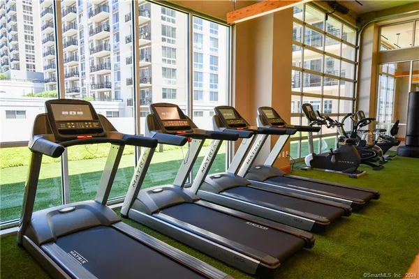a view of a living room with furniture and floor to ceiling windows