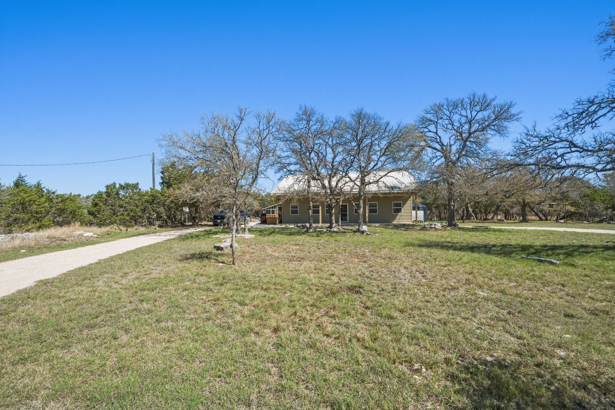 1301 Altwein Road Blanco, TX 78606 - Photo 6 of 40 Single story home with a front lawn and covered porch