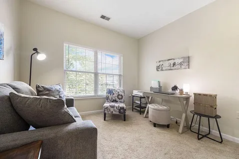 a living room with furniture and a large window