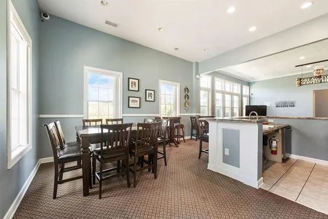 a living room with a couch and a mirror