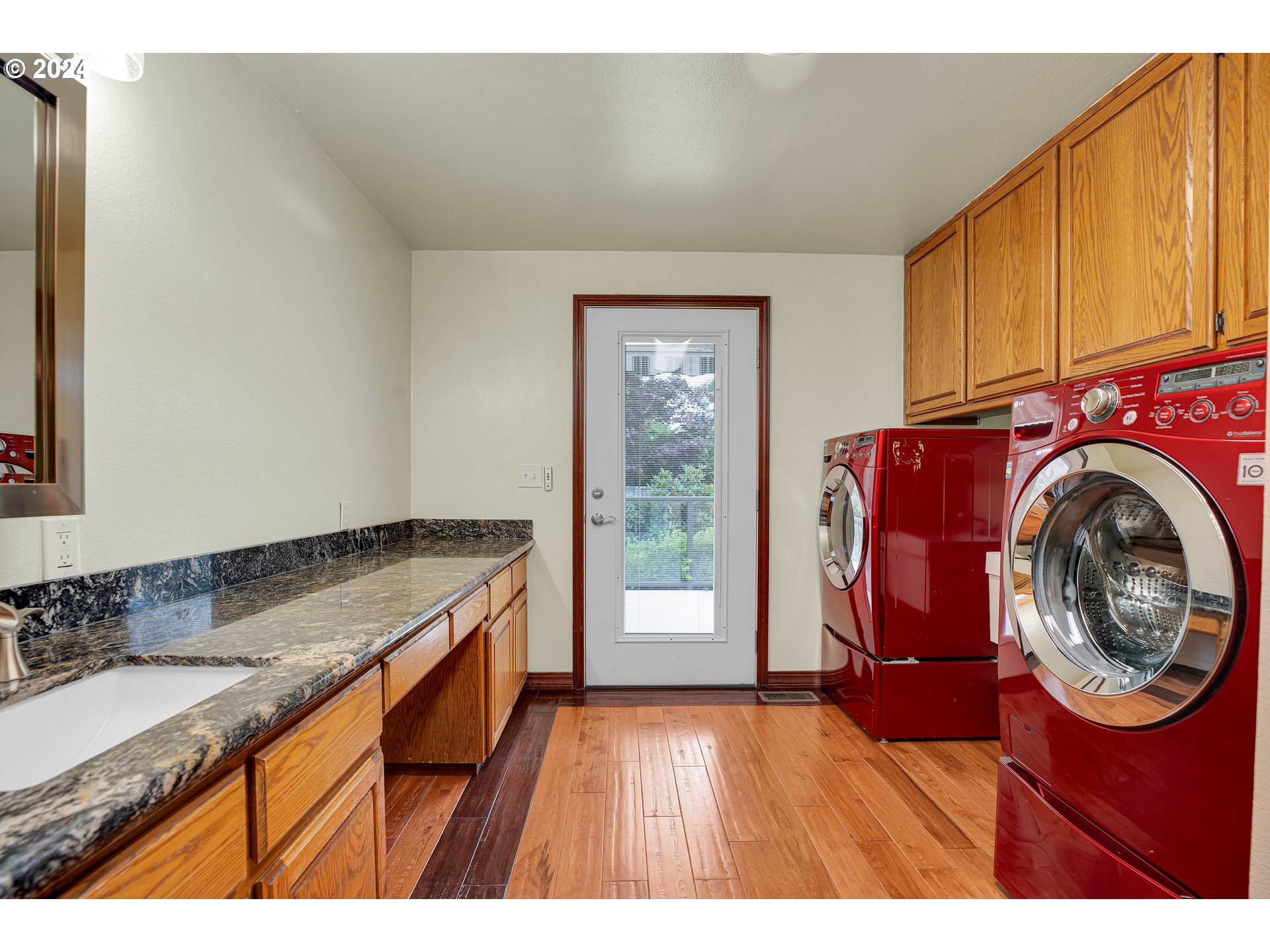 28930 Southeast Powell Valley Road Gresham, OR 97080 - Photo 21 of 38 a kitchen view with granite countertop a sink a stove and wooden floor