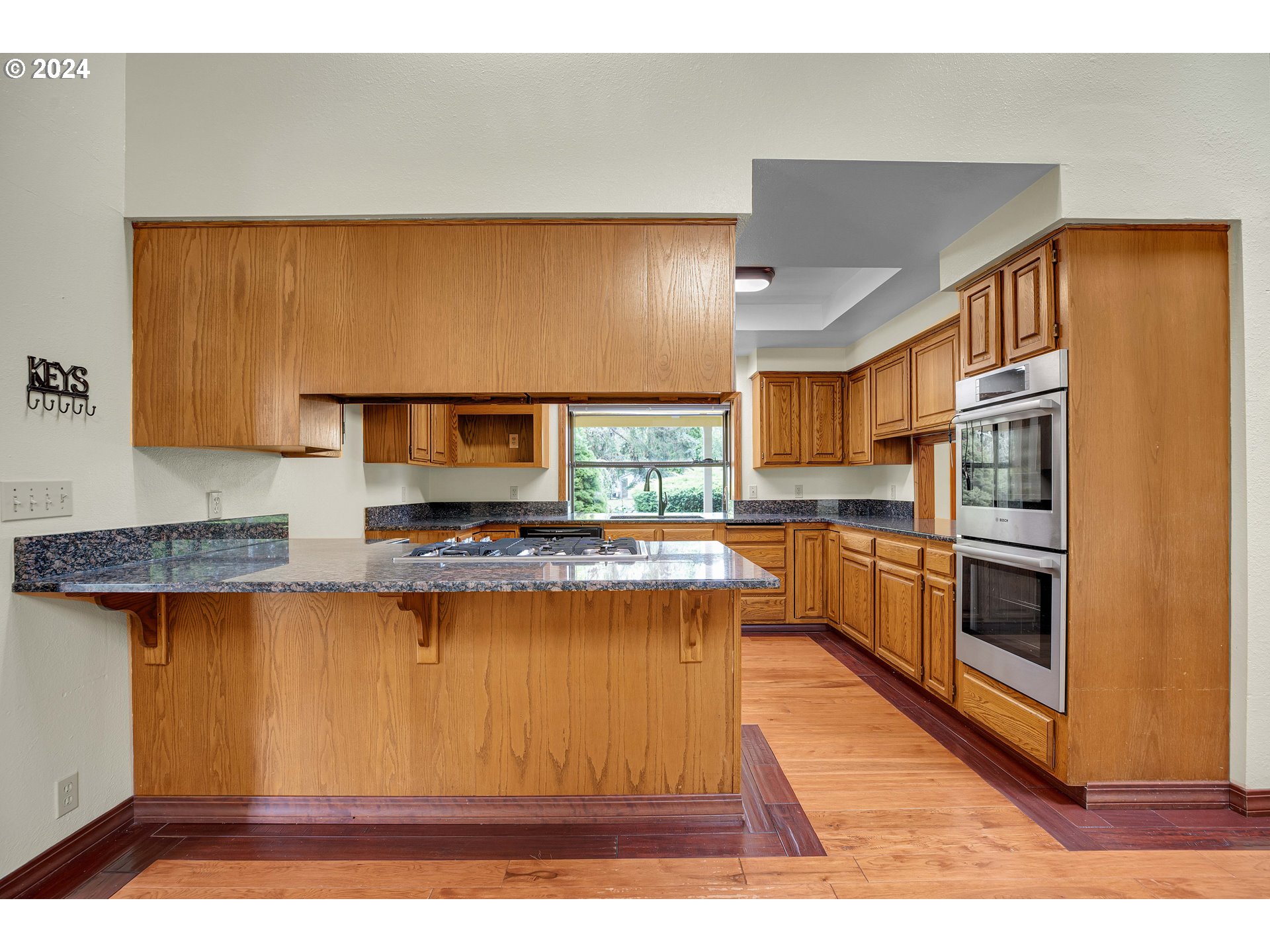 28930 Southeast Powell Valley Road Gresham, OR 97080 - Photo 7 of 38 a kitchen with stainless steel appliances granite countertop a stove a sink and a refrigerator