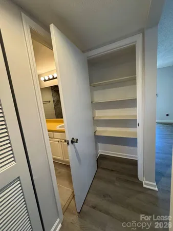 a view of a room with wooden floor