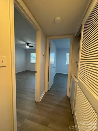 a view of a hallway with wooden floor