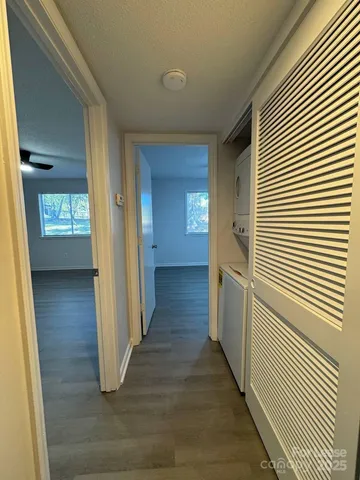 a view of a hallway with wooden floor and staircase