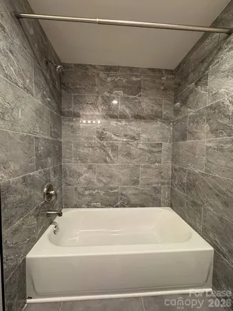 a bathroom with a shower and bathtub