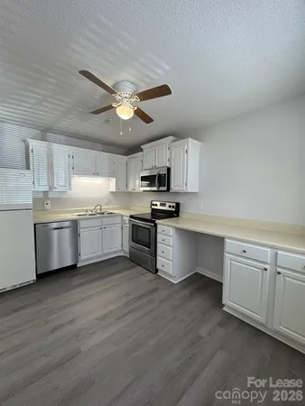 a kitchen with a white cabinets and stainless steel appliances