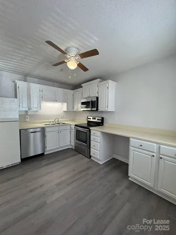 a kitchen with a white cabinets and stainless steel appliances