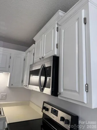 a view of cabinets and wooden floor