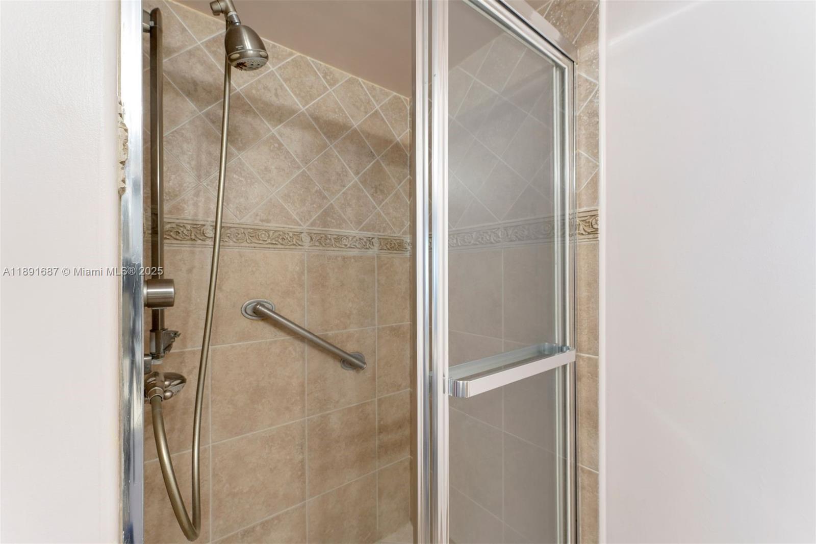 1000 Quayside Terrace, Unit PH9 Miami, FL 33138 - Photo 16 of 27 a bathroom with a glass shower door